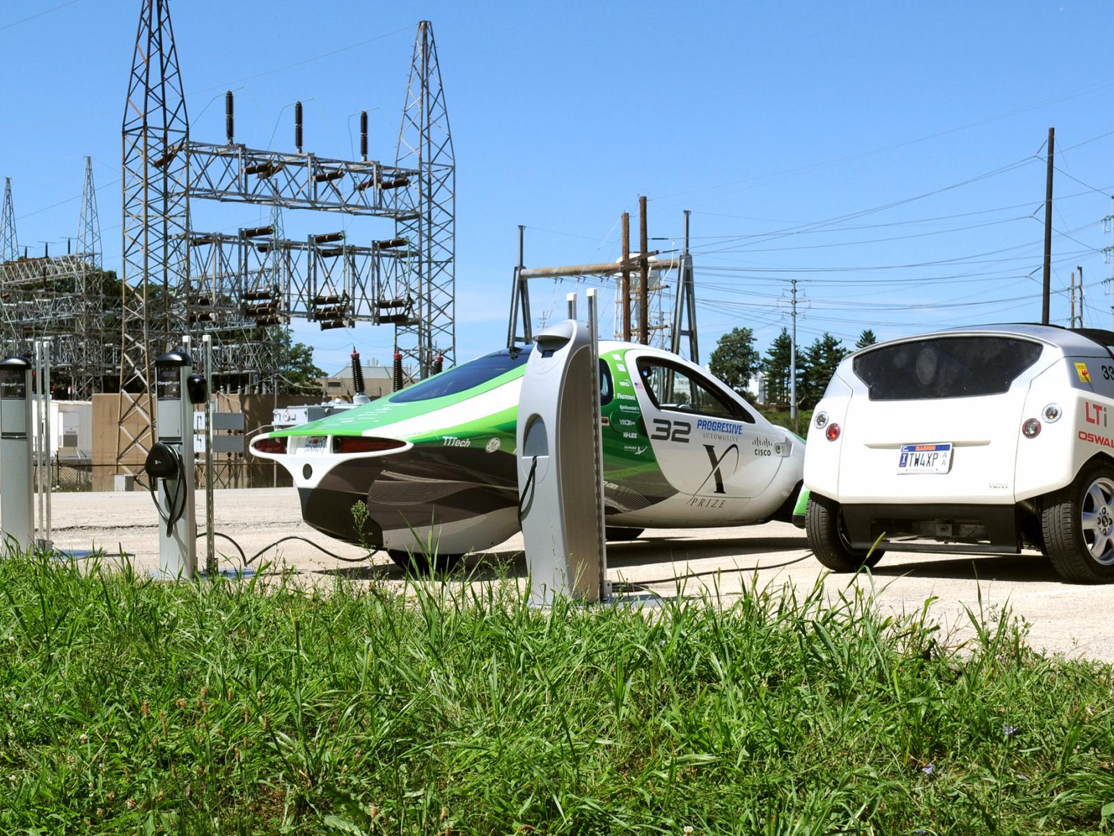 two electric vehicles next to a substation