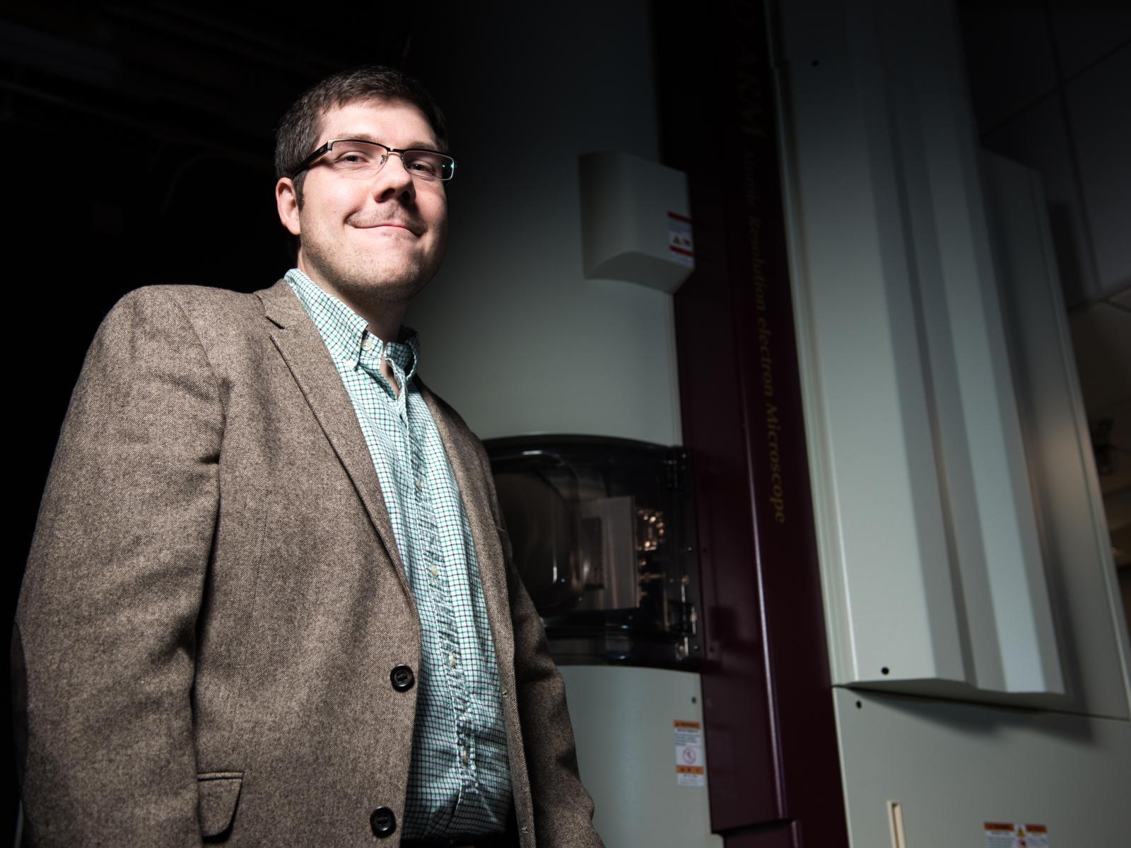 Photo of Steve Spurgeon standing next to a laboratory instrument.