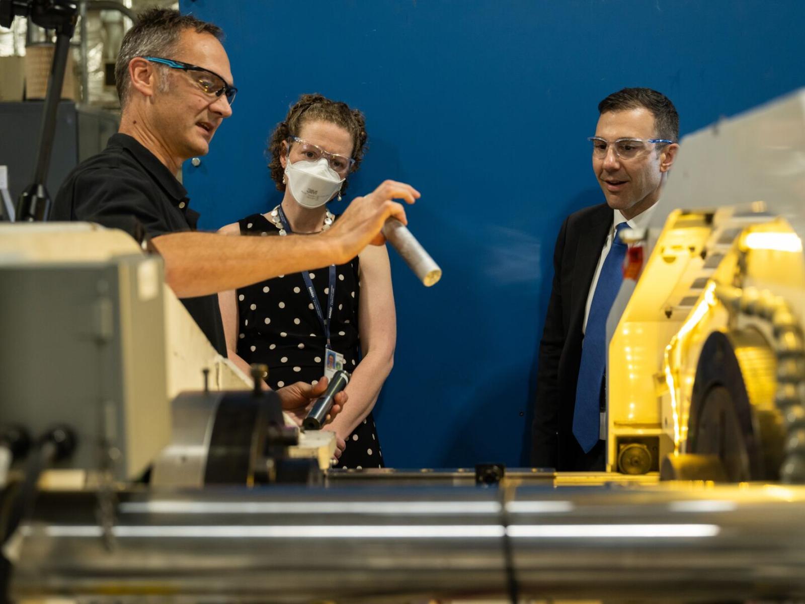 Scott Whalen showing aluminum ingot to EERE visitors