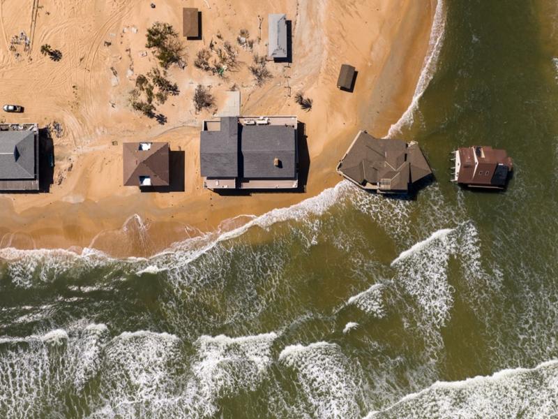 bird's eye view of flooded homes along a shoreline